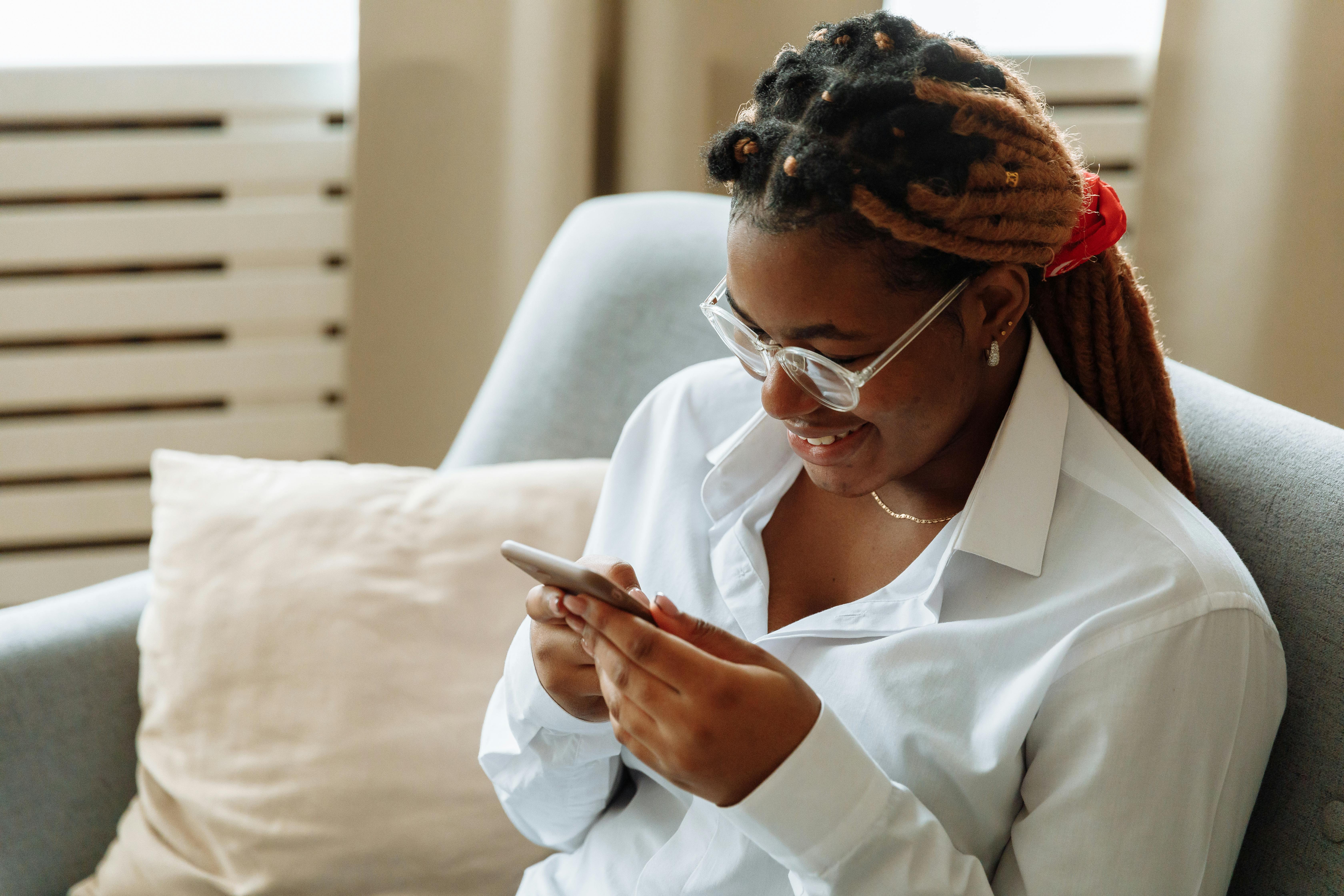 Hairstylist checking bookings on her phone